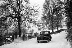 Morris Ten Saloon in snowy lane with trees 1947