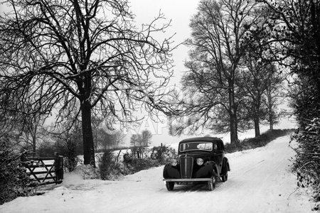 Morris Ten Saloon in snowy lane with trees 1947