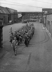 Men Marching Through Yard